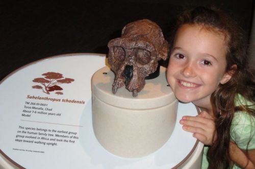 my daughter Leilani with Sahelanthropus tchadensis skull at Smithsonian